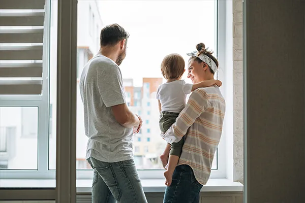 safe family looking out an apartment window